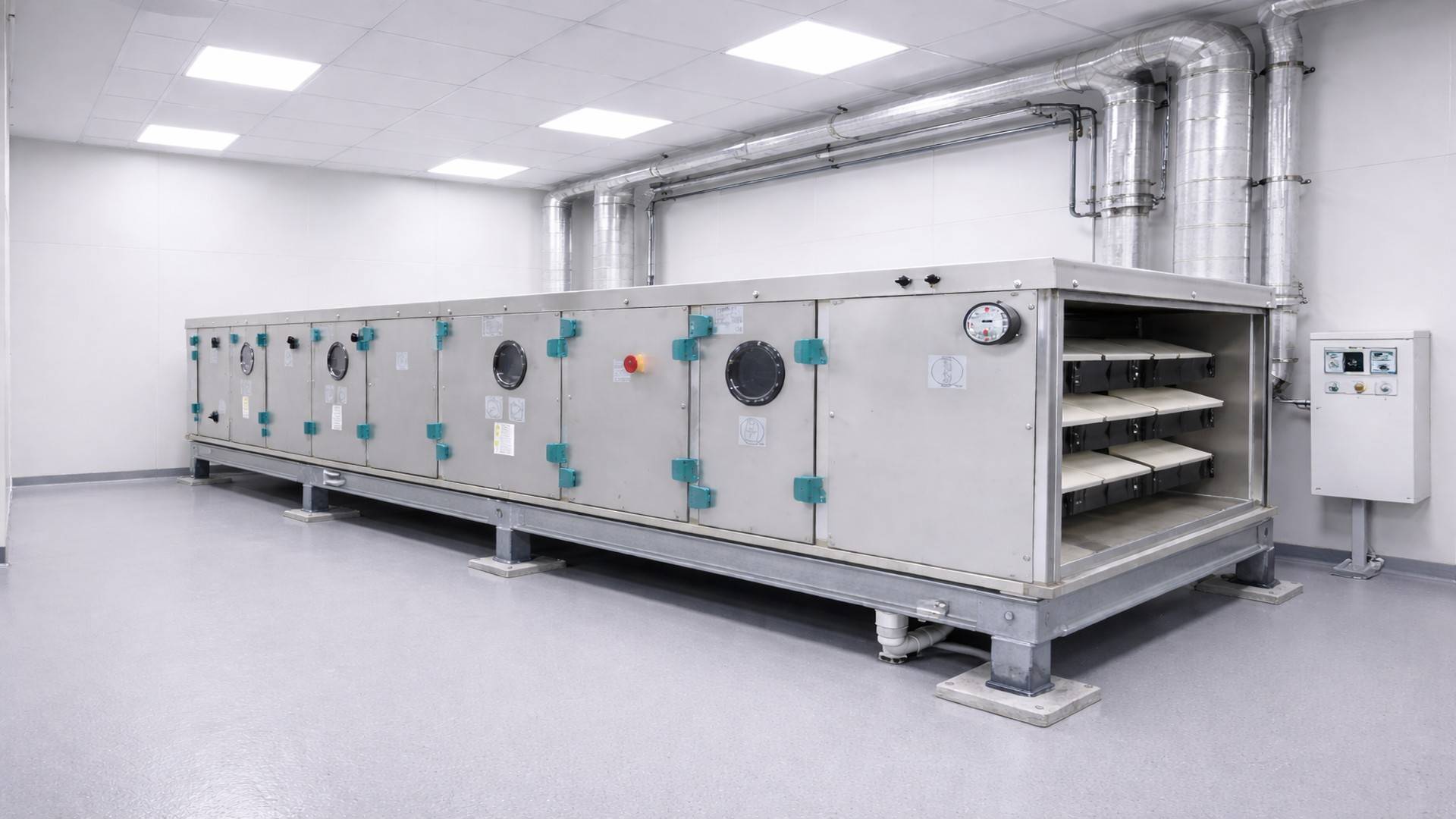 Air handling unit installed in a hospital mechanical room, mounted on an elevated metal frame, with visible ventilation ducts and an electrical panel.